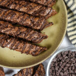 a plate of double chocolate biscotti and a dish of chocolate chips