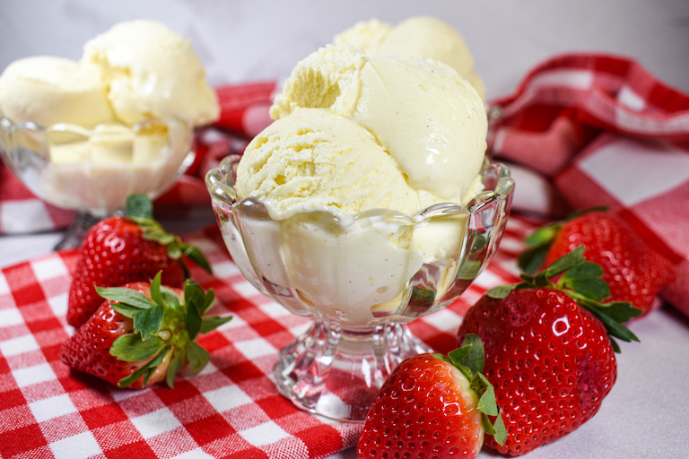 Dishes of cheesecake ice cream with fresh strawberries
