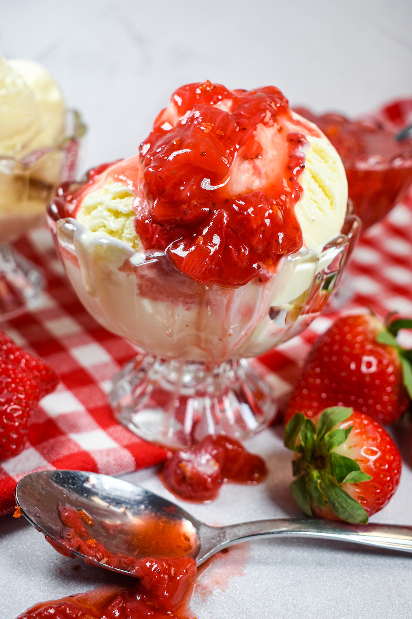 Cheesecaek ice cream drizzled with strawberry compote
