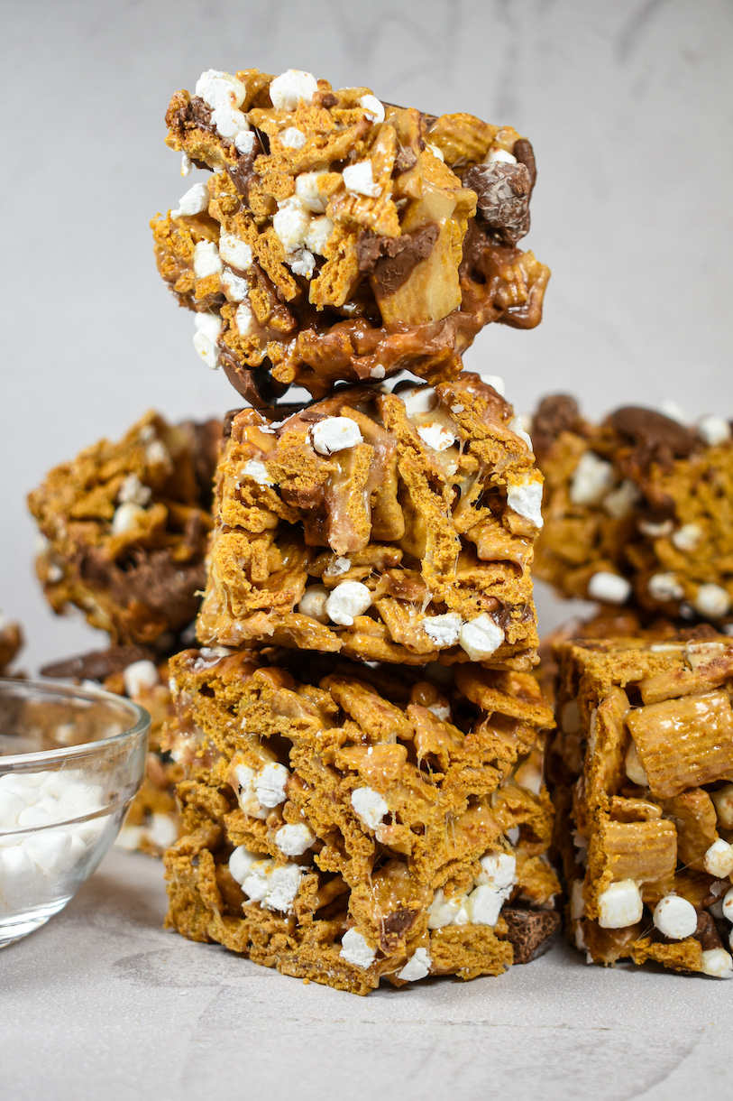 A stack of three s'mores cereal treats on a white surface
