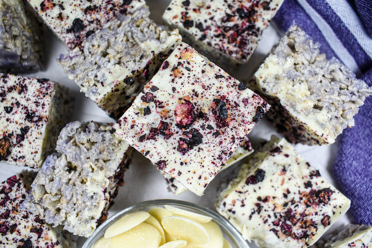 A stack of blueberry rice krispie treats and a purple tea towel