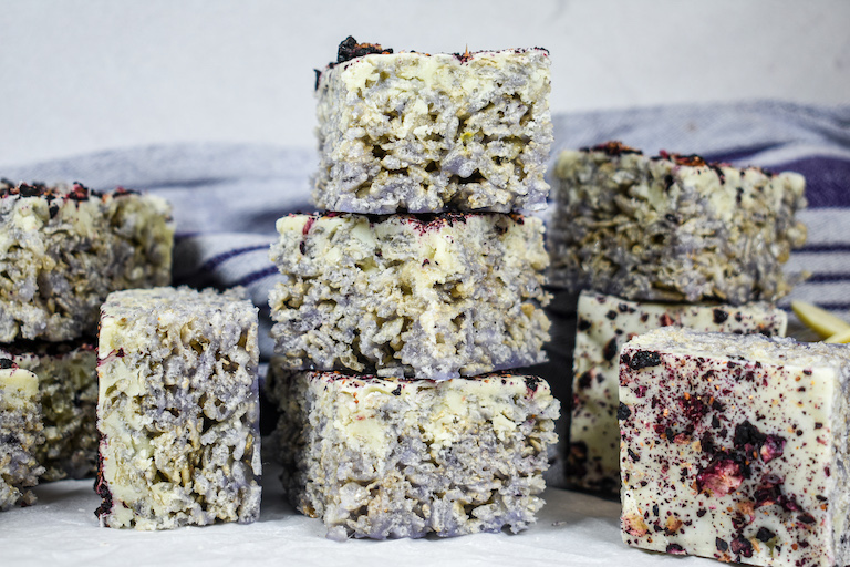 A stack of blueberry krispie treats on a white surface