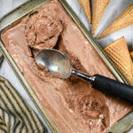 a loaf pan of chocolate ice cream and a scoop
