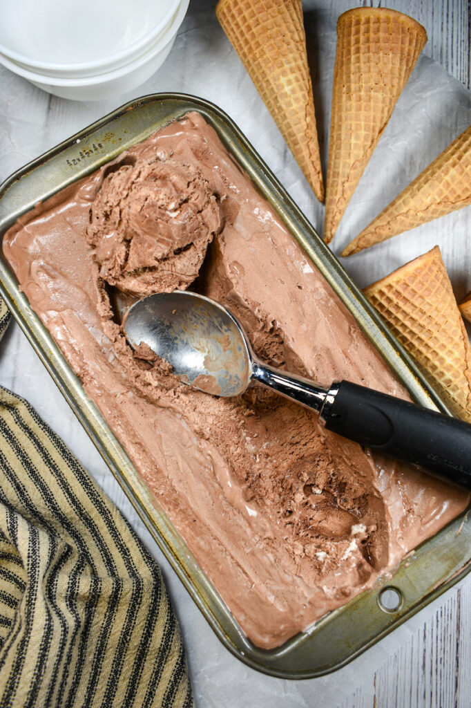 a loaf pan of chocolate ice cream and a scoop