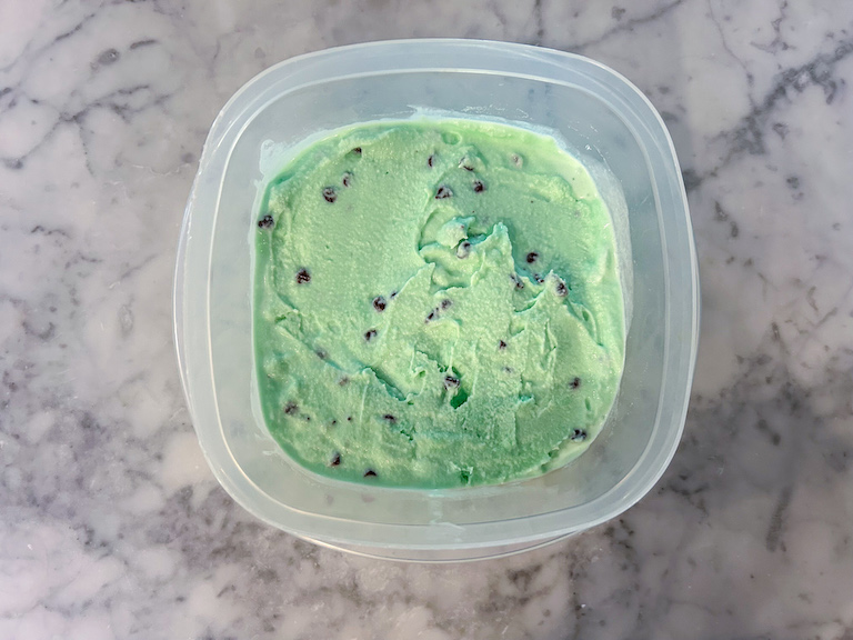 Mint chocolate chip ice cream in a plastic container