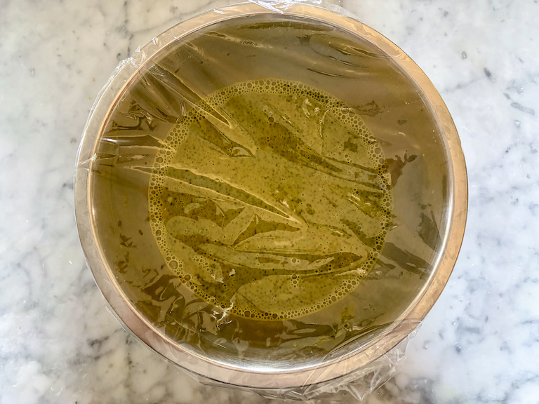 Bowl of matcha chia seed pudding covered in clingfilm