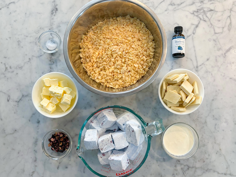 Blueberry krispie treat ingredients arranged on a marble surface
