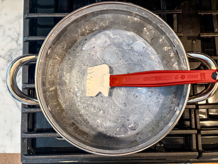 Melted blueberry marshmallows in a pan on the stovetop