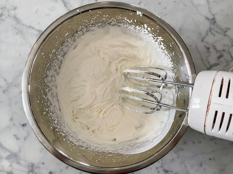 Cream in a large bowl with a hand mixer
