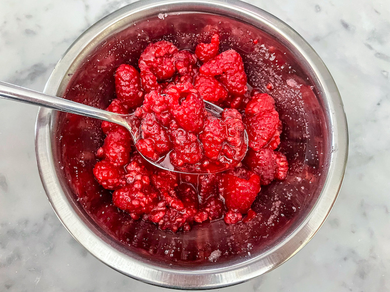 A spoonful of macerated raspberries