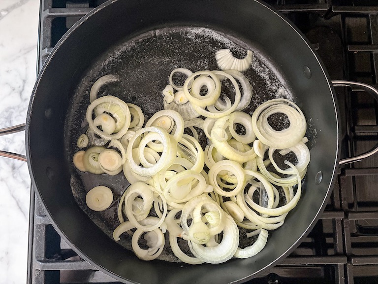 A pan of raw onion rings