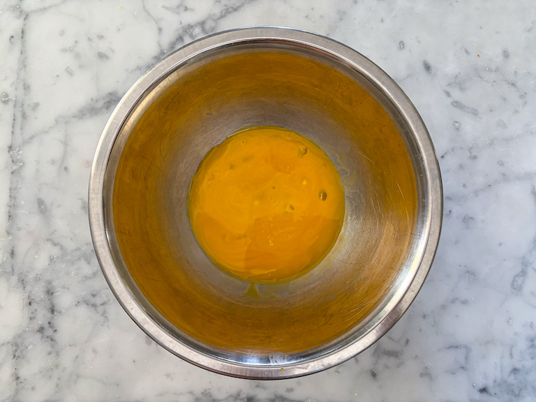 Bowl of egg yolks on a marble surface