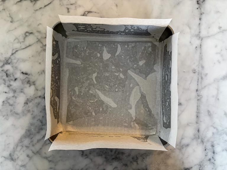 A square parchment lined tin