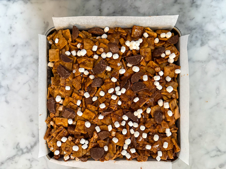A pan of s'mores treats decorated with marshmallows and milk chocolate