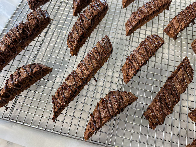 Double chocolate biscotti slices arranged on a wire rack