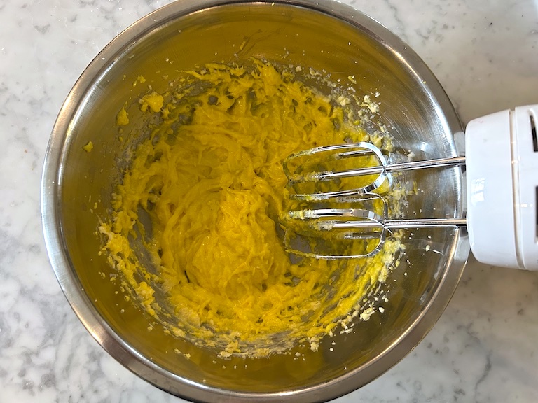 Mixer mixing lemon whoopie pie batter in a bowl