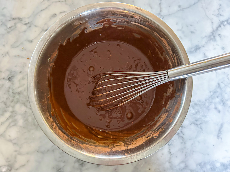 No churn chocolate ice cream base in a bowl with a whisk