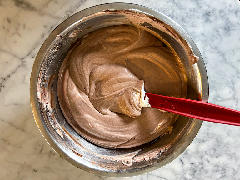 spatula folding together chocolate and whipped cream