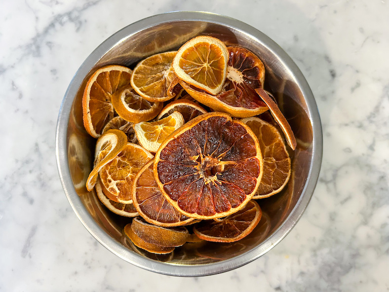 A bowl of dried orange, lemon, and grapefruit slices
