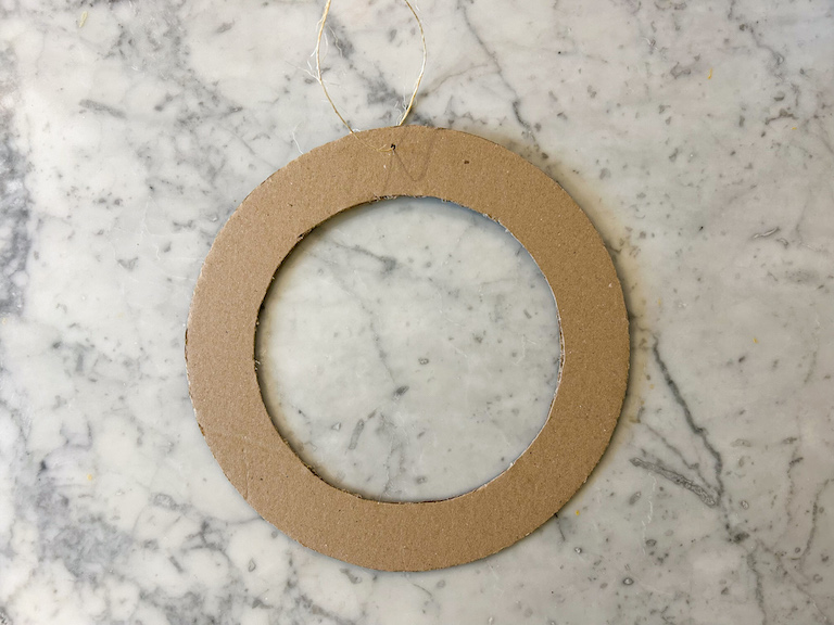 A cardboard ring on a marble surface