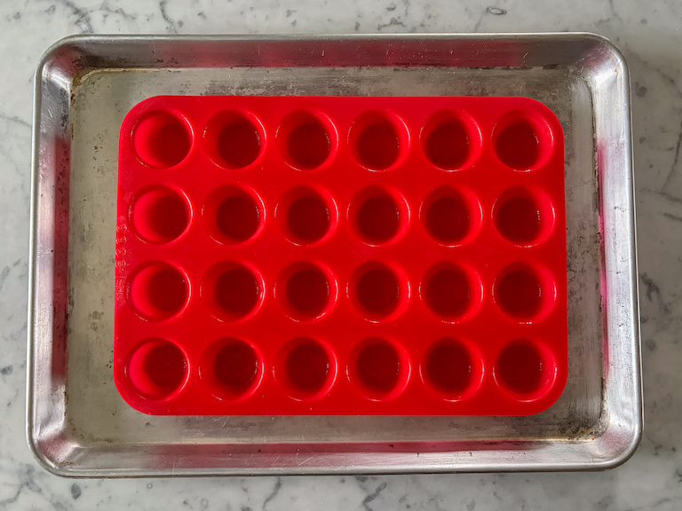 Silicone muffin pan on a metal tray