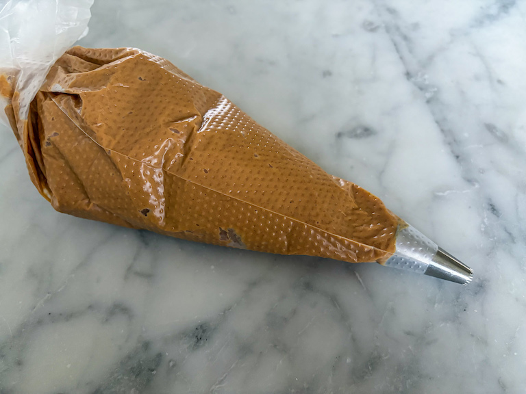 A piping bag filled with peanut butter