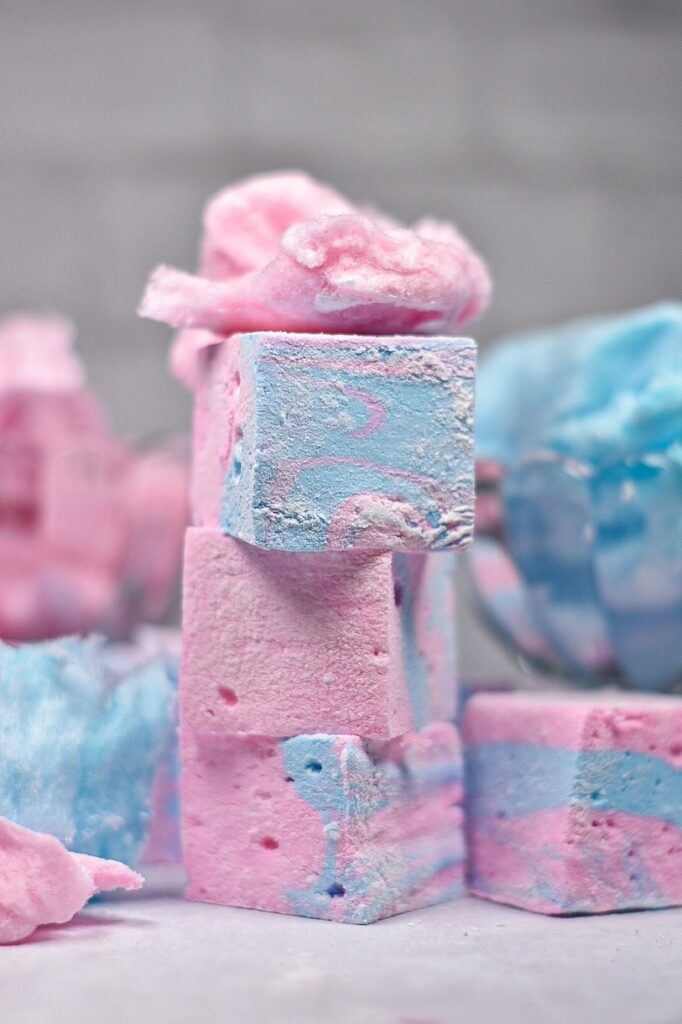 Stack of three cotton candy marshmallows with pink spun sugar on top