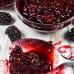A splattered spoonful of blackberry compote