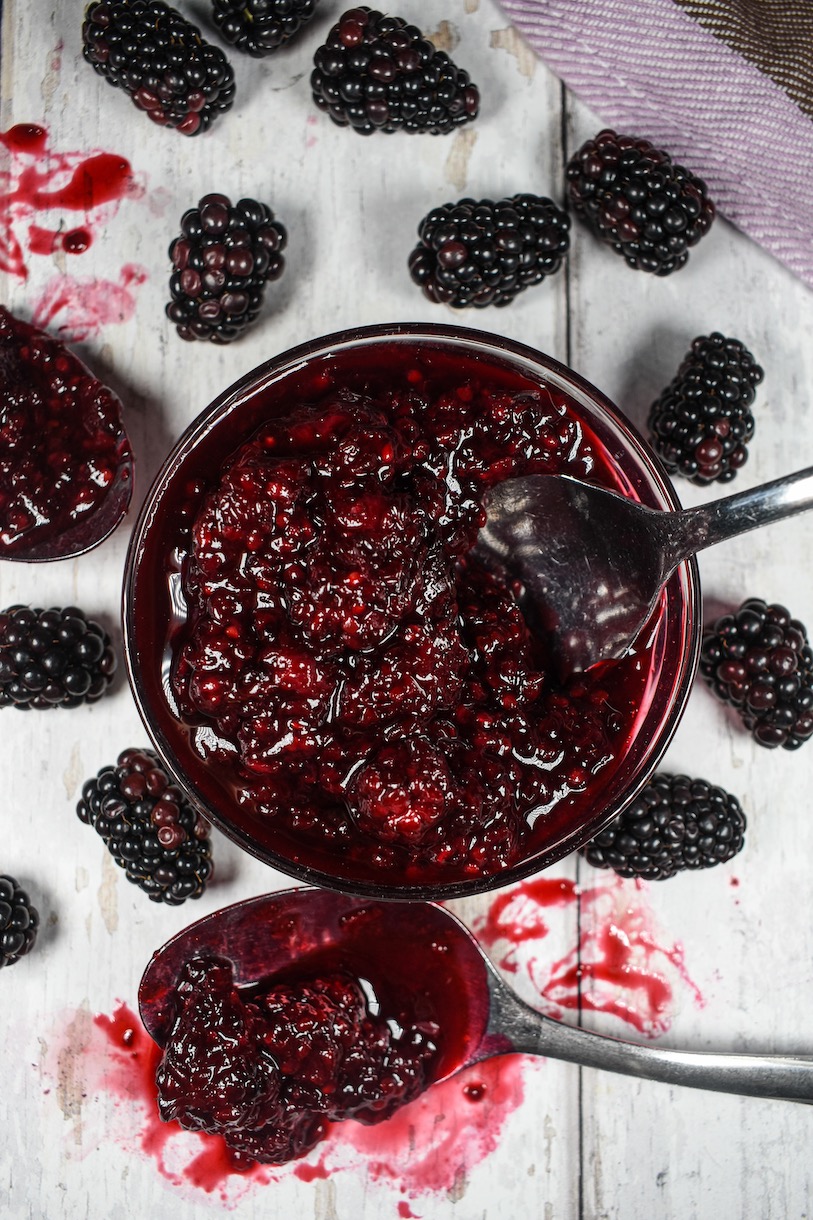 A dish of blackberry compote and a spoon