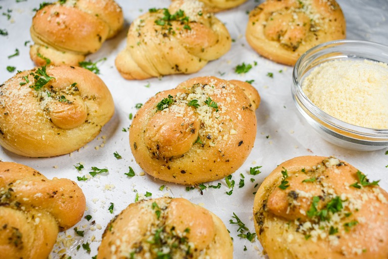 Garlic knots sprinkled with herbs and cheese