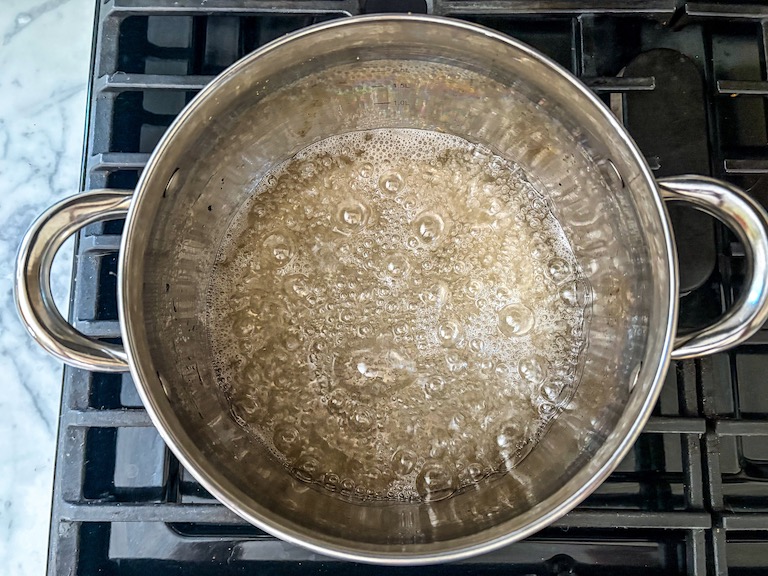 Sugar syrup cooking in a pan on the stovetop