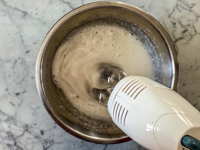 Mixer mixing sugar syrup into marshmallow fluff