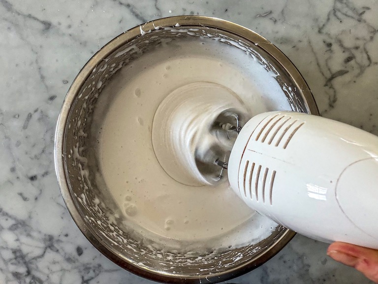 Mixer mixing a bowl of marshmallow fluff