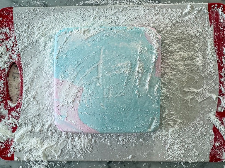 A slab of marshmallow on a sugar-dusted chopping board