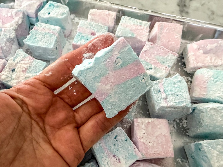 Hand holding a cotton candy marshmallow