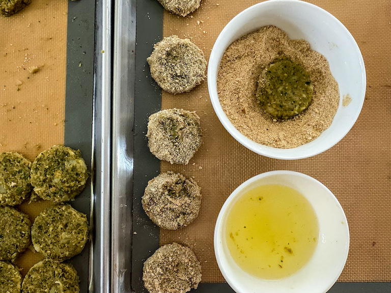 Dunking nuggets in egg white and breadcrumbs
