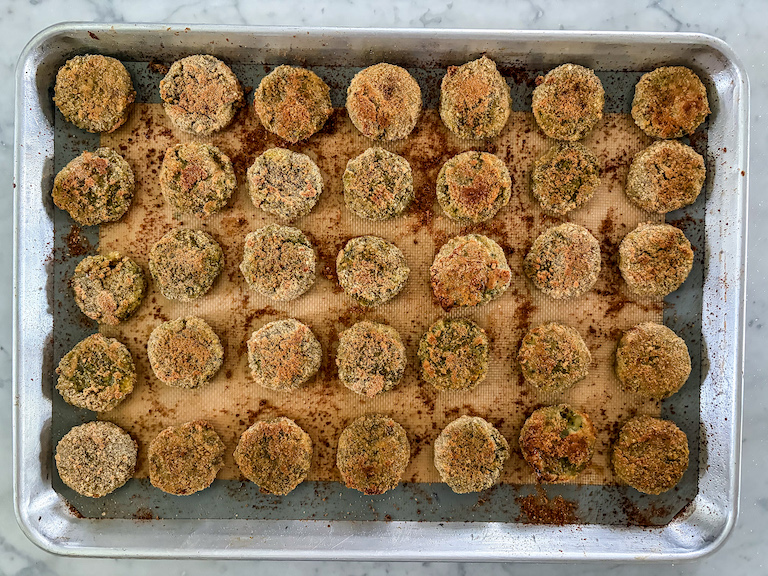 Golden brown baked vegetable nuggets on a tray