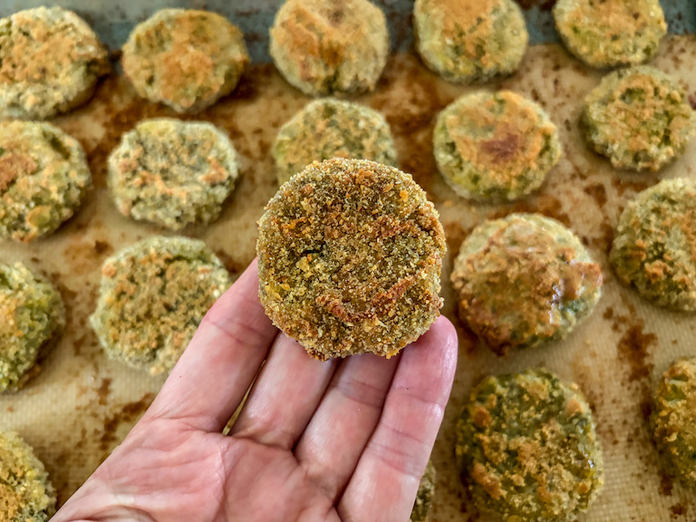 Hand holding a baked vegetable nugget