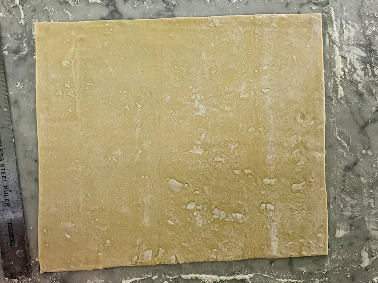 puff pastry rolled on countertop