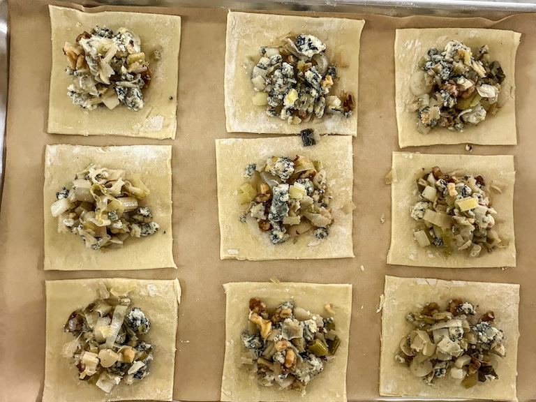 Spooning blue cheese filling into puff pastry squares