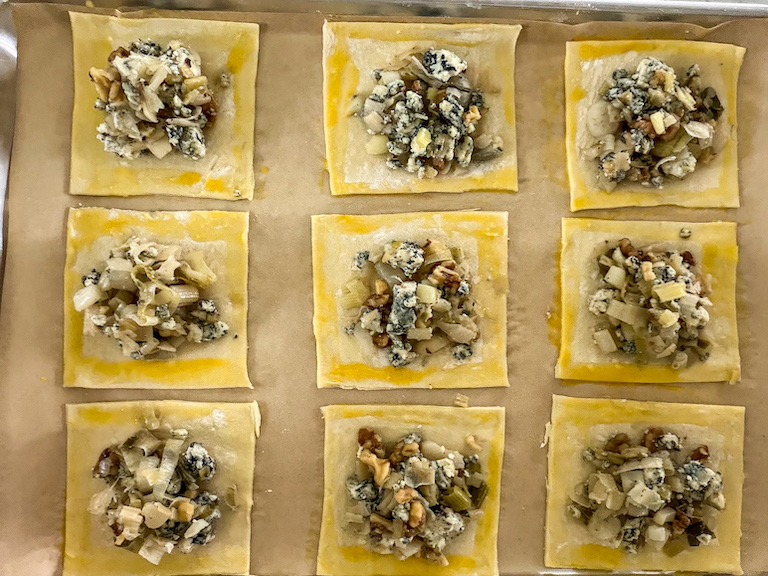 Egg washing edges of puff pastry hand pies