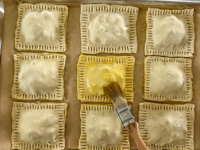 Brushing hand pies with egg wash