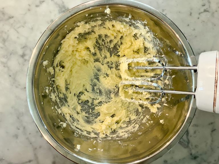 butter in a bowl with a mixer