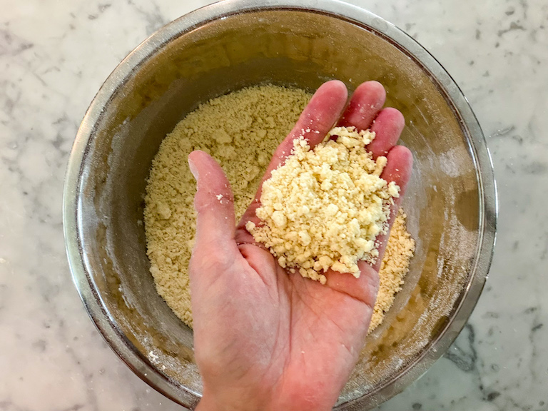 hand holding crumbly shortbread dough