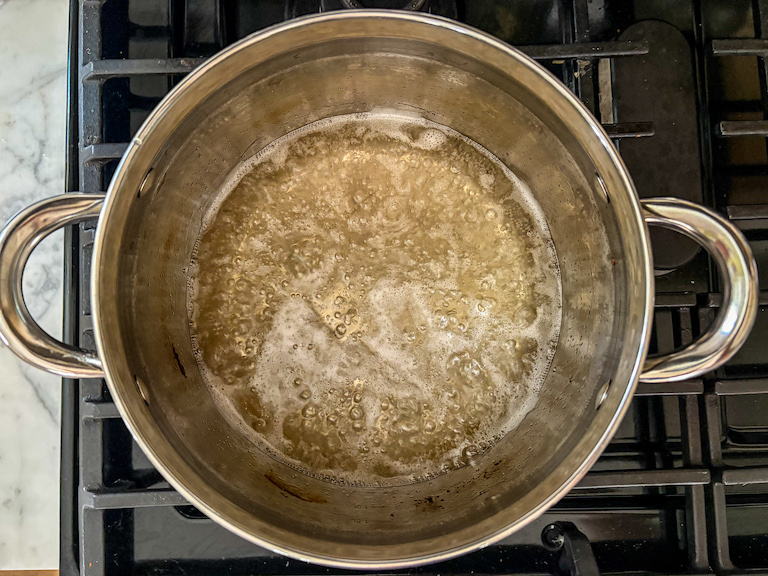 Sugar syrup simmering in a saucepan