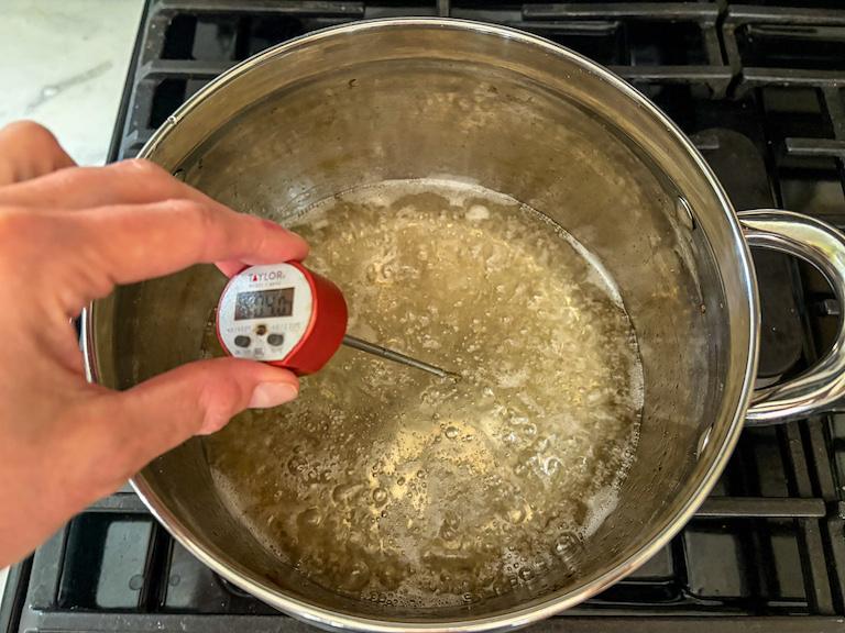 taking the temperature of sugar syrup with a digital thermometer