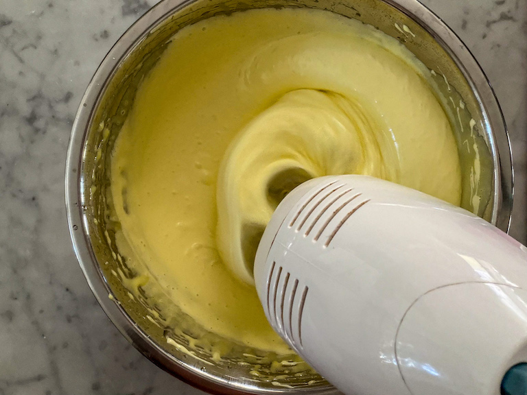 Mixer mixing a bowl of marshmallow fluff