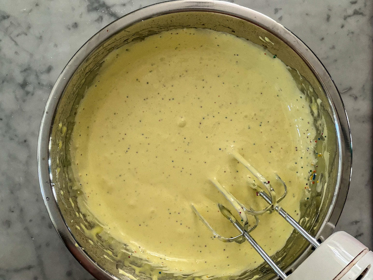 Yellow marshmallow fluff in a metal bowl