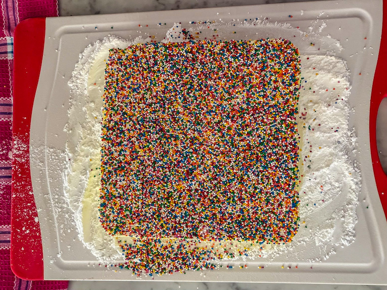 sprinkle covered marshmallow slab on a cutting board
