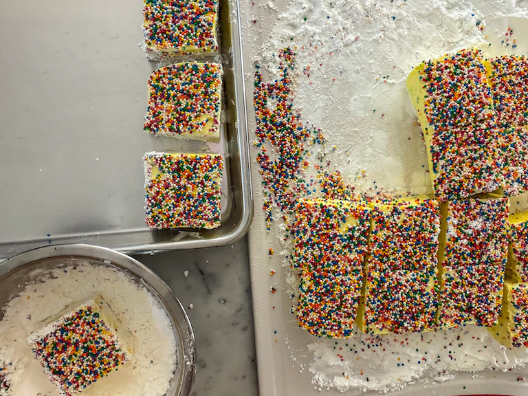 Coating birthday cake marshmallows in cornflour and powdered sugar